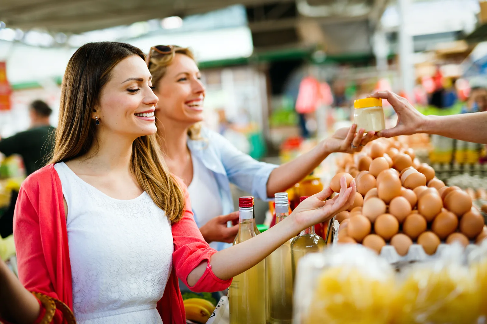 Customers choosing fresh eggs from a supermarket display